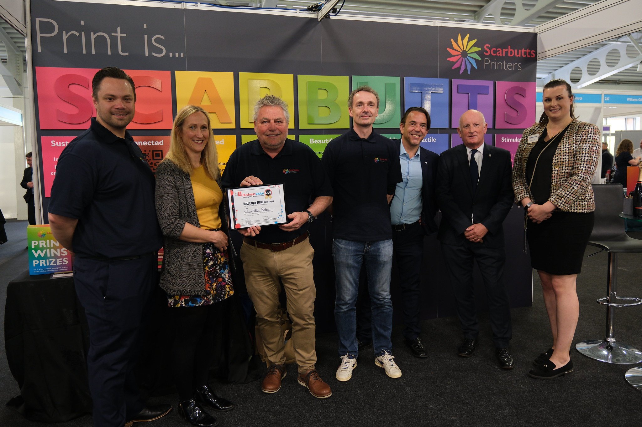 The Scarbutts Printers team at Business Vision Live 2023 with the award for Best Large Stand